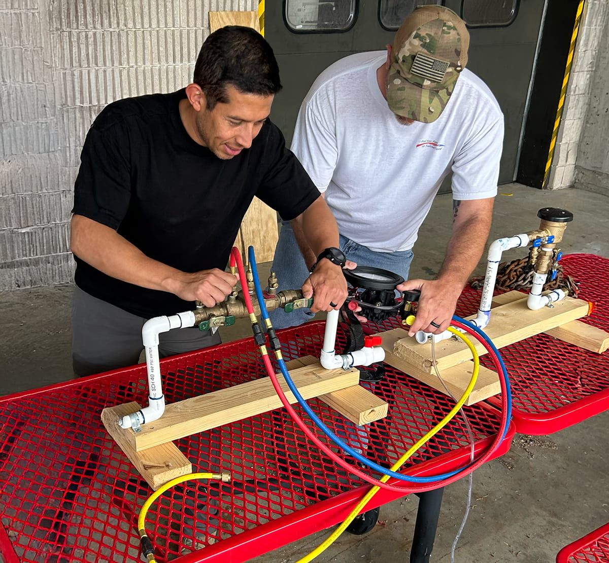 Student earning backflow testing certification after completing backflow certification course